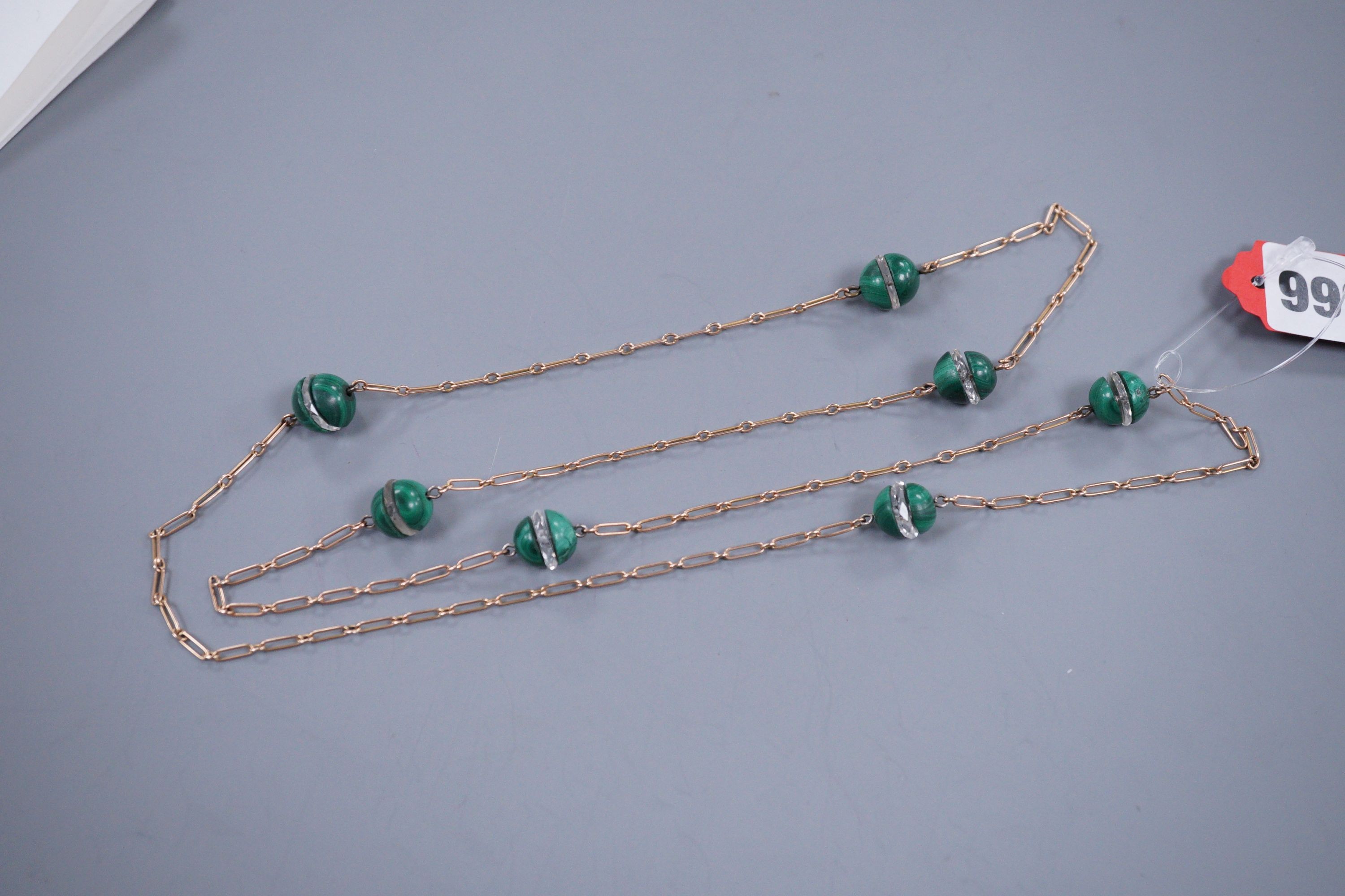 A gold, malachite and glass chain necklace, 82cm (tests as 9ct), gross 24.3 grams